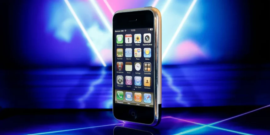 A Sleek Modern Smartphone Sitting On A Tabletop Next To A Digital Workstation