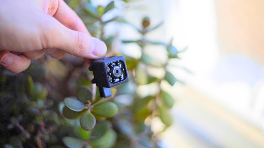 A Magnetic Led Grid Clip-On Device Attached To A Smartphone Camera Scanning For Hidden Camera Lenses